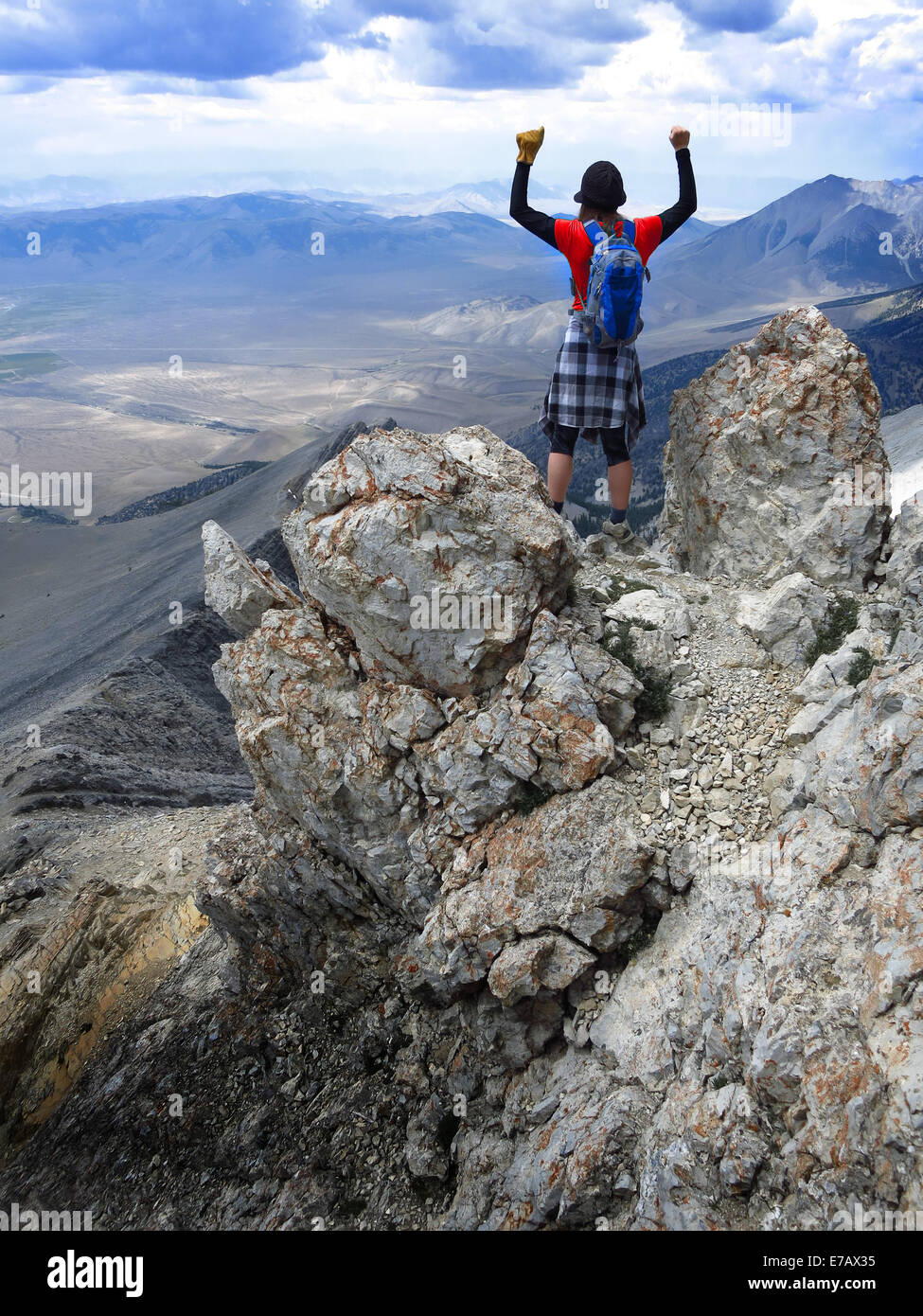 Girl hiker summit mountain top in triumph Stock Photo