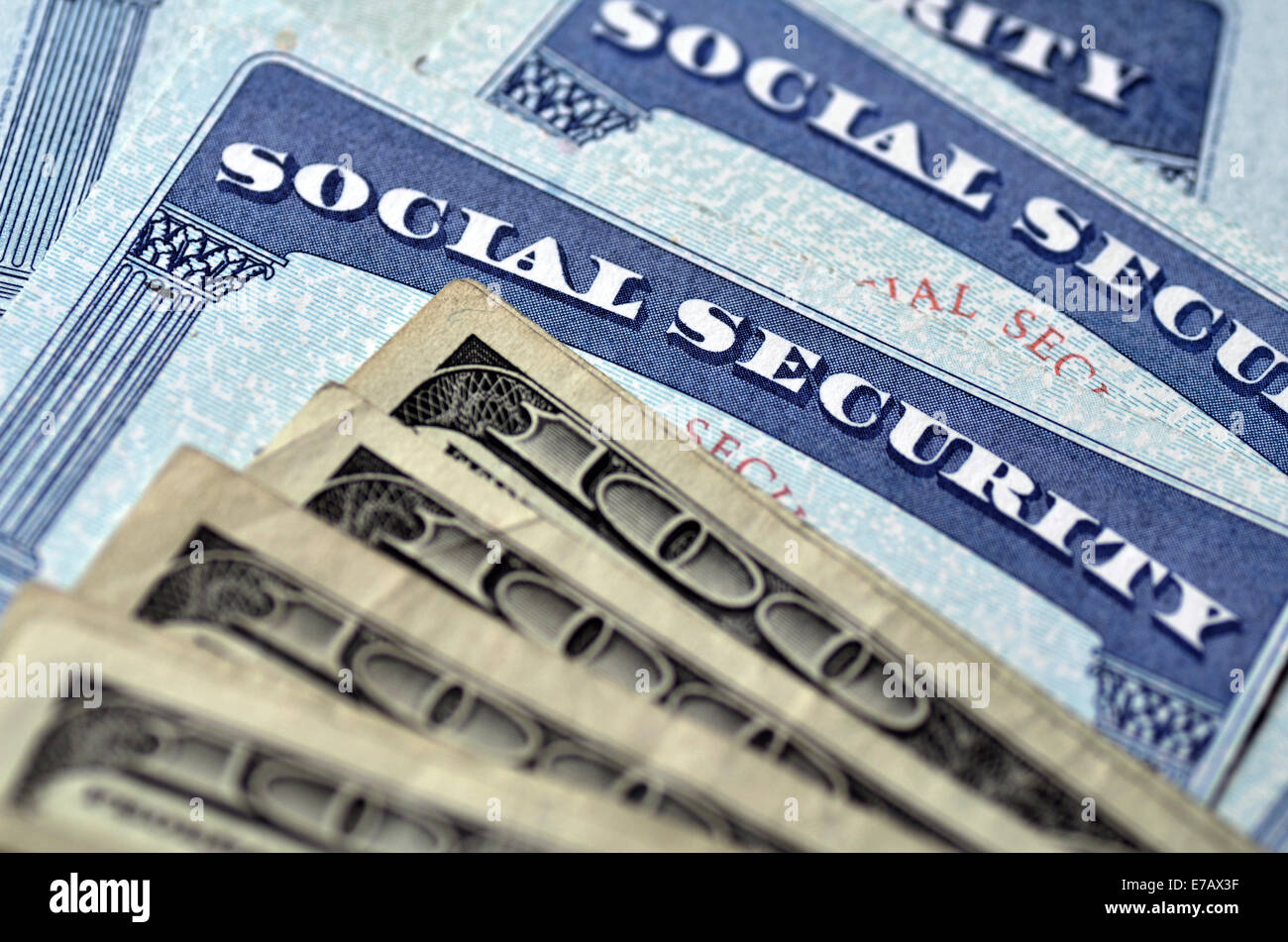 Detail of several Social Security Cards and cash money symbolizing retirement pensions financial safety Stock Photo