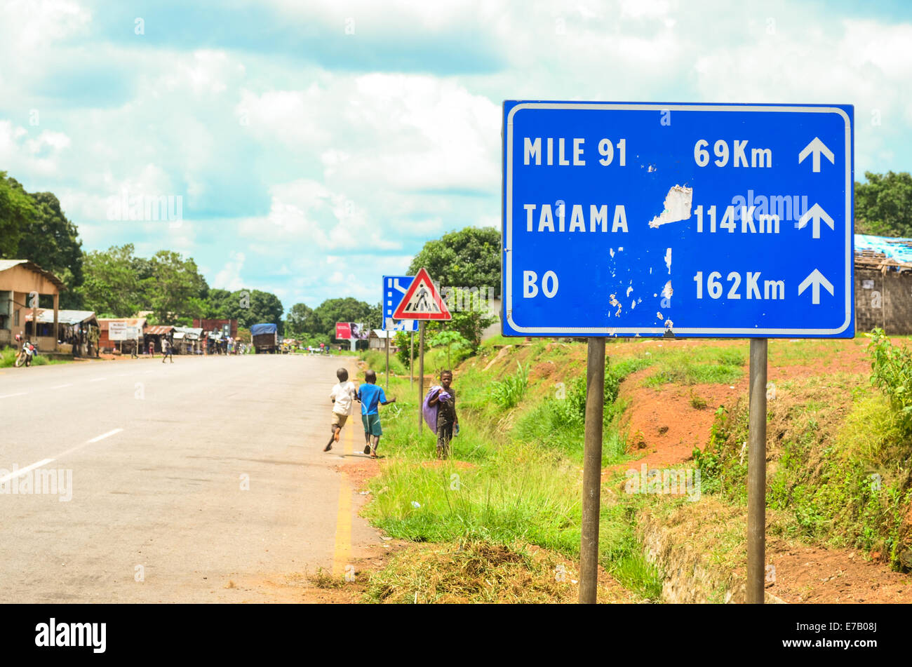 Road sign in Sierra Leone, directions eastbound (Liberia) to Mile 91, Taiama and Bo Stock Photo