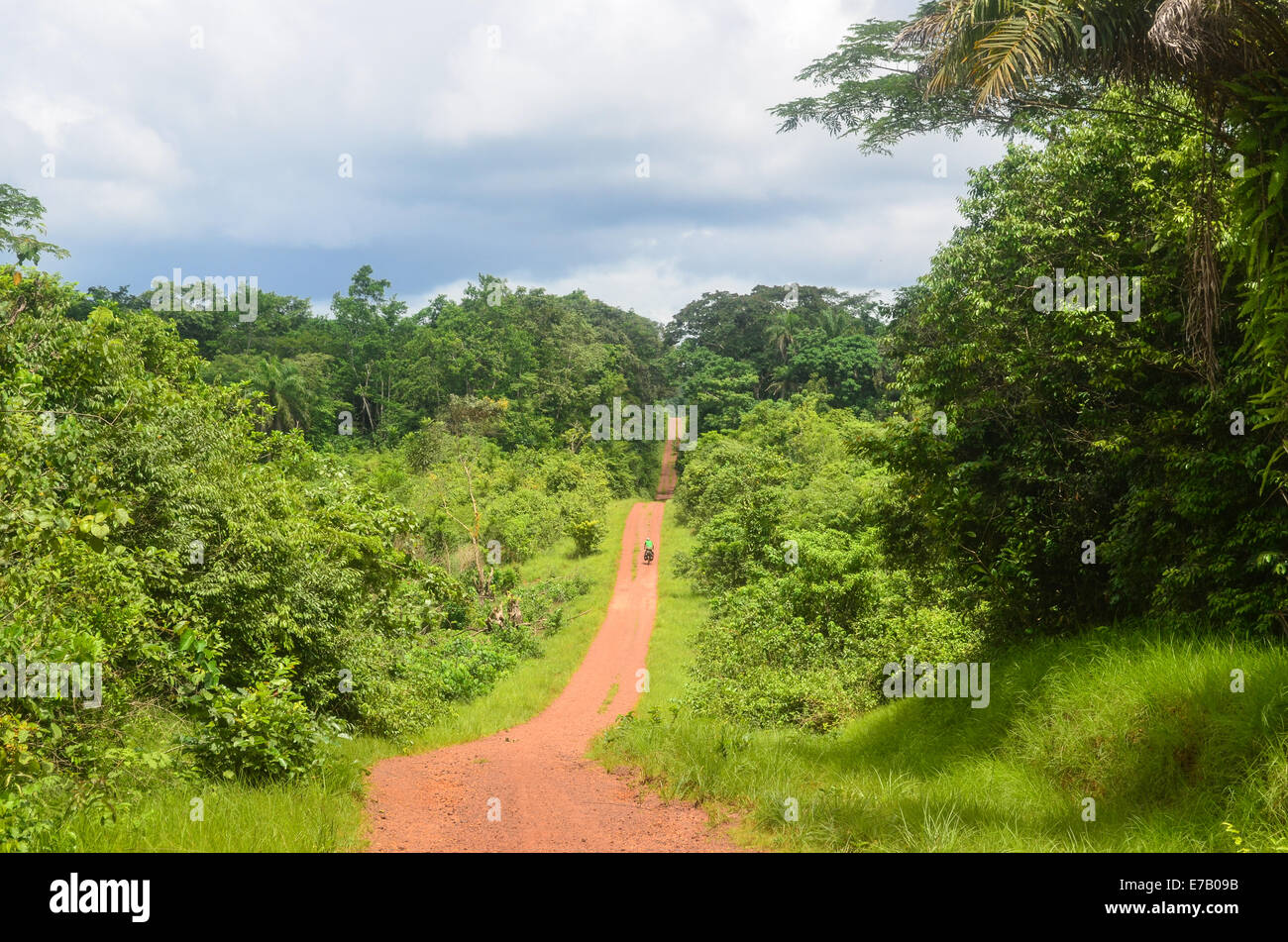 Travelling on the red earth dirt roads of eastern Sierra Leone to Liberia Stock Photo