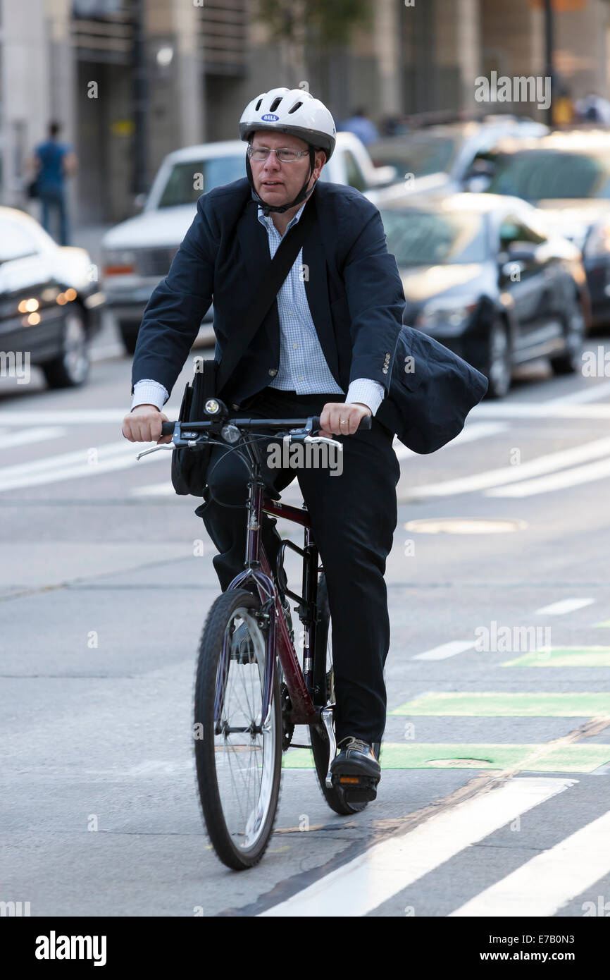 Seattle, Washington, USA. 11th Sep, 2014. Man in a suit cycling on Second Avenue along the Second Avenue Protected Bike Lane Demonstration Project - Seattle, King County, Washington, USA. September 8, 2014 Seattle Department of Transportation opened the protected bike lane on Second Avenue between Pike Street and Yesler Way. The project also includes segments on Pike Street between First and Second avenues and on Yesler Way between Second Avenue and Occidental Way. Credit:  Paul Gordon/Alamy Live News Stock Photo