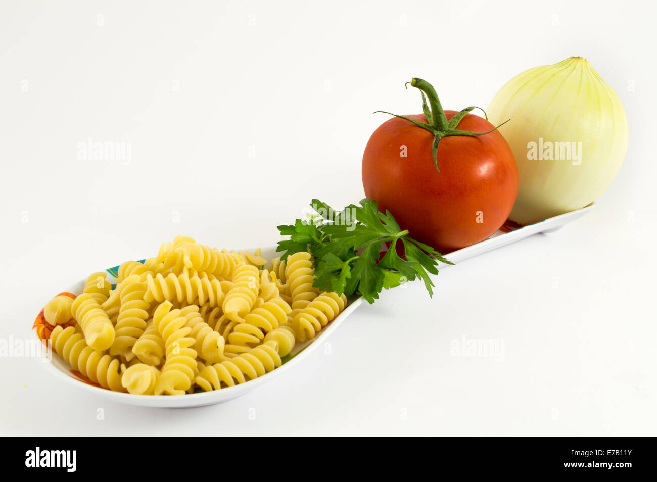 onion, tomato, parsley pasta on white background Stock Photo