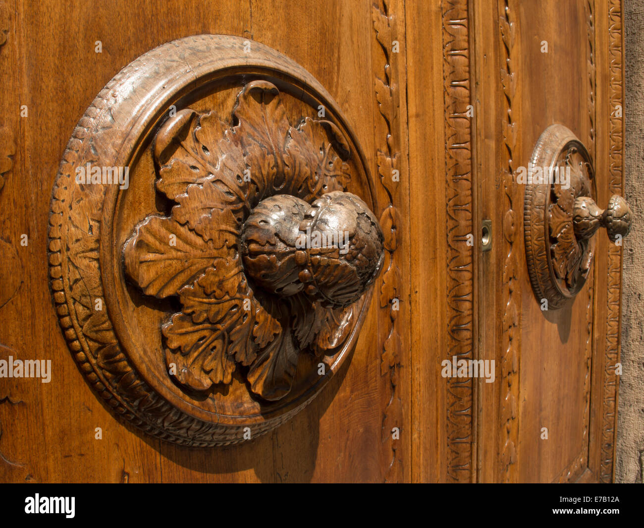 Wooden door in Arezzo in the foreground with a rosette Stock Photo