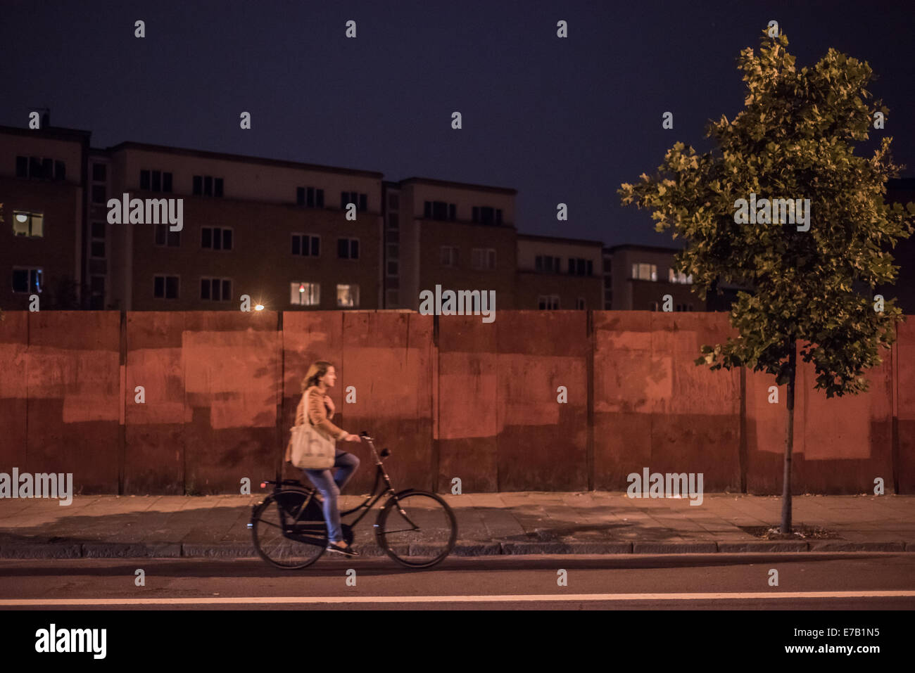 London, UK. 11 September 2014: a woman rides her bike on Kingsland Road in Dalston, North-East London. Credit:  Piero Cruciatti/Alamy Live News Stock Photo