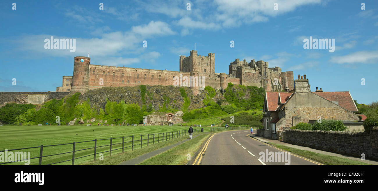 Panoramic View Of Huge And Historic Bamburgh Castle On Grassy Hill