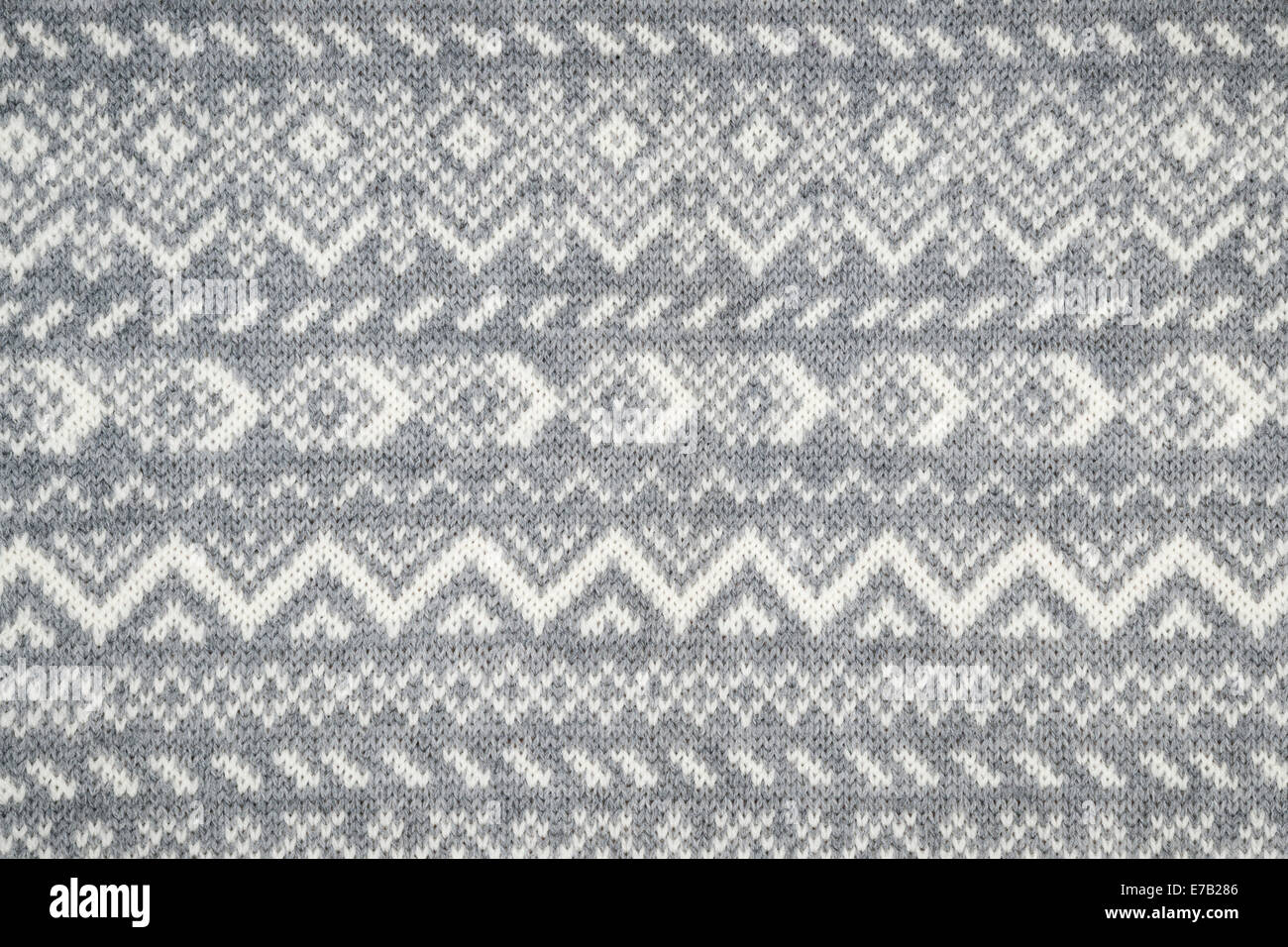 Knit fabric background with knitted grey and white geometric pattern Stock Photo