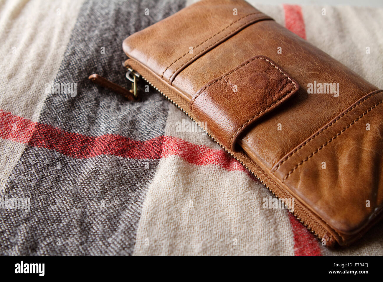 Brown leather purse on a hessian fabric scarf Stock Photo
