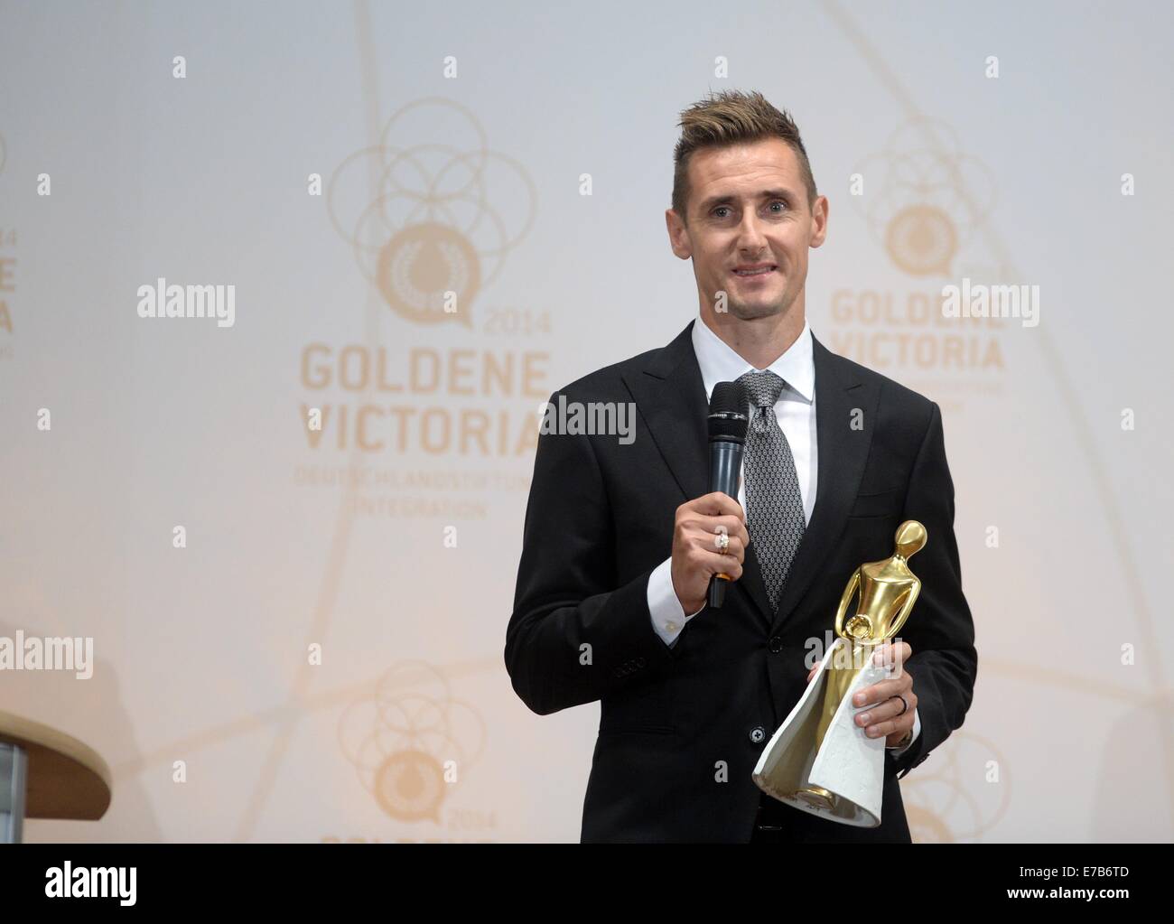 Berlin, Germany. 11th Sep, 2014. Soccer world champion Miroslav Klose accepts the 'Goldene Victoria' award from the Deutschlandstiftung Integration in Berlin, Germany, 11 September 2014. Photo: BRITTA PEDERSEN/dpa/Alamy Live News Stock Photo