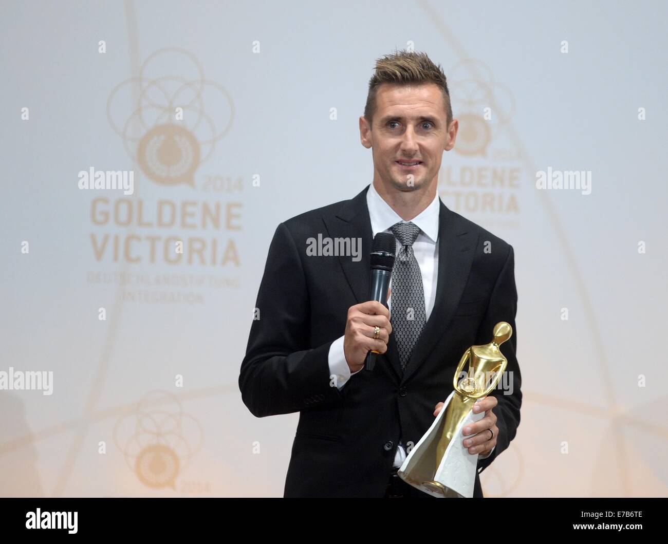 Berlin, Germany. 11th Sep, 2014. Soccer world champion Miroslav Klose accepts the 'Goldene Victoria' award from the Deutschlandstiftung Integration in Berlin, Germany, 11 September 2014. Photo: BRITTA PEDERSEN/dpa/Alamy Live News Stock Photo