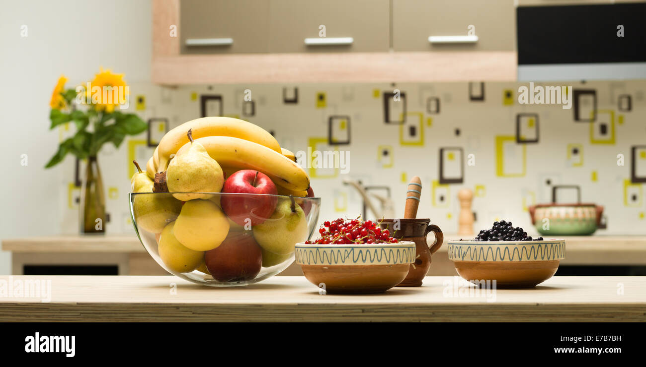 closeup of glass bowl with fruits on kitchen countertop Stock Photo