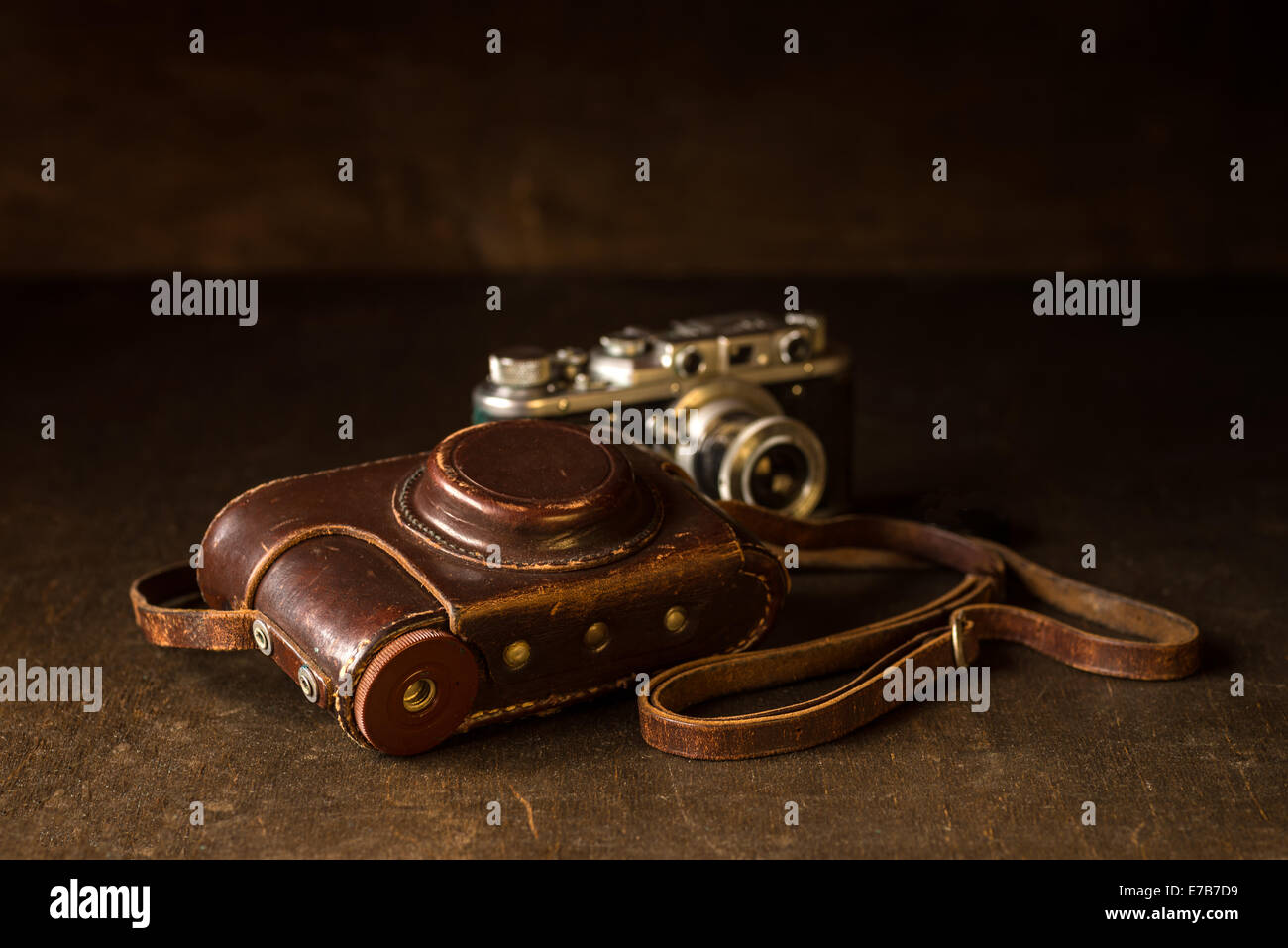 Still life with old leather cover and photo camera Stock Photo