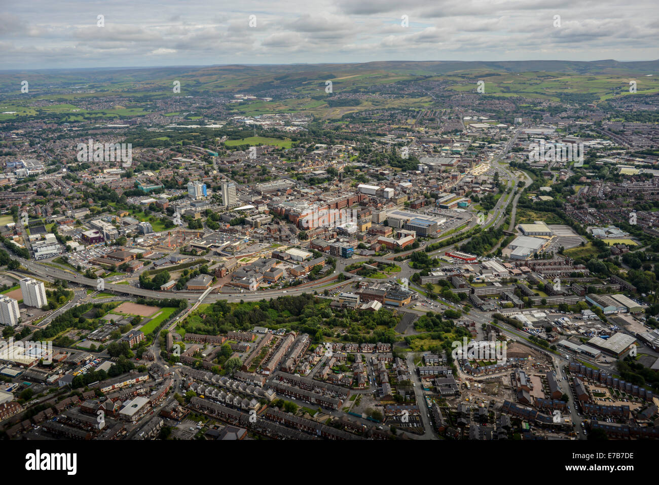 An aerial view across the centre of Oldham, Greater Manchester. Open countryside is visible in the distance. Stock Photo
