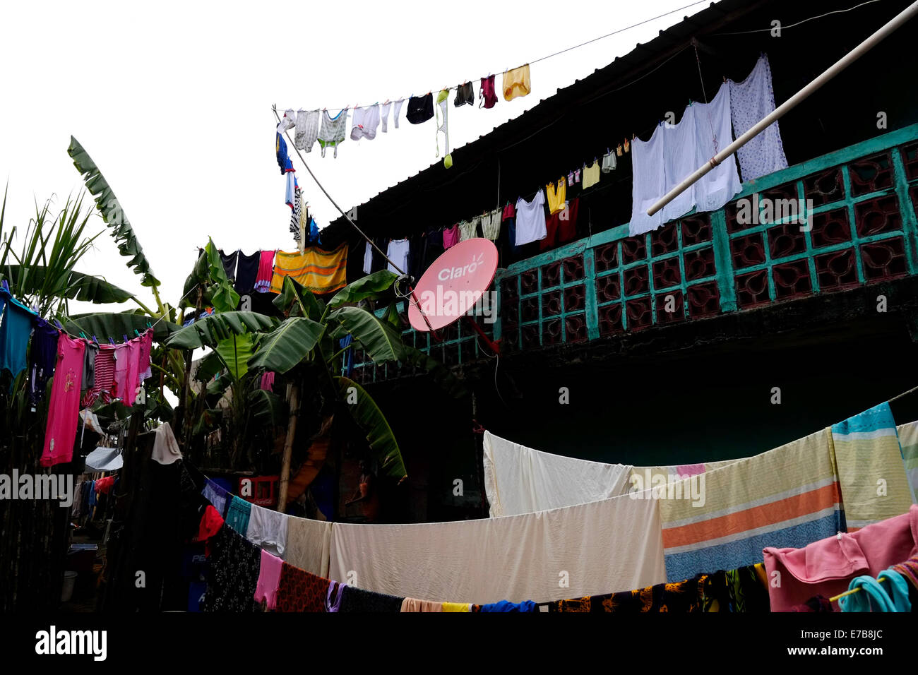 Satellite dish amid laundry in Carti Sugtupu island village administered by Guna natives known as Kuna in the 'Comarca' (region) of the Guna Yala located in the archipelago of San Blas Blas islands in the Northeast of Panama facing the Caribbean Sea. Stock Photo