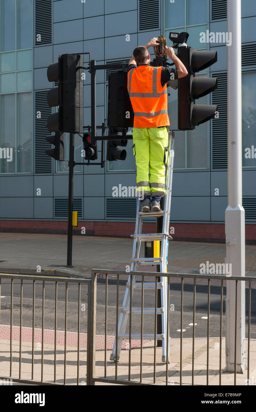 Engineer fixing some traffic lights Stock Photo Alamy