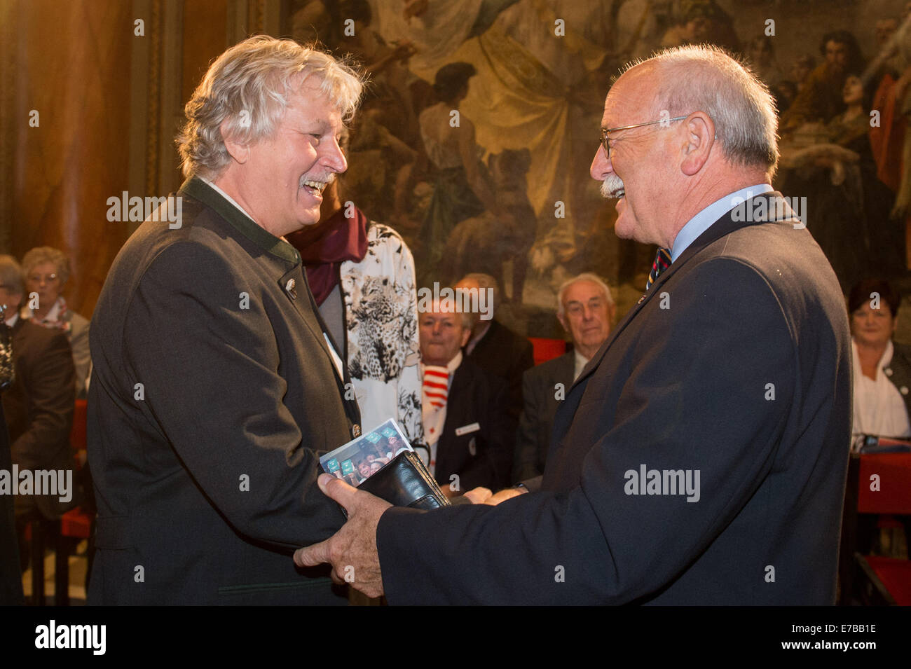 Passau, Germany. 12th Sep, 2014. Gerhard Meyer (C), the first East German refugee in the tent camp in Vilshofen and Hans Gschwendtner (CSU), former mayor of Vilshofen, stand in the historical City Hall in Passau, Germany, 12 September 2014. 25 years ago thousands of East Germans traveled to Austria and West Germany via Hungary after it opened its border to Austria. The Bavarian parliament is commemorating this historic moment with a ceremony in Passau. Photo: ARMIN WEIGEL/dpa/Alamy Live News Stock Photo
