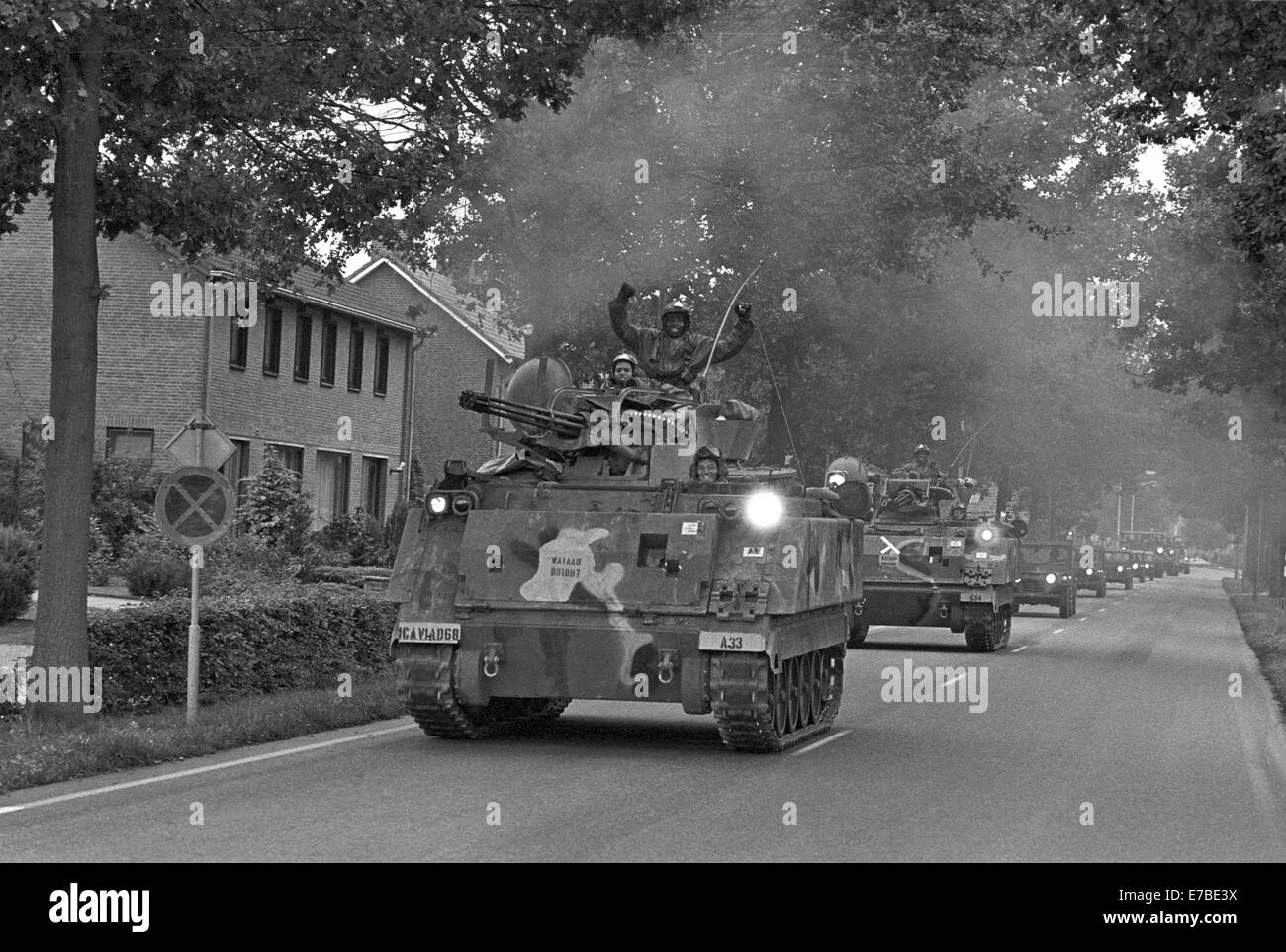 NATO exercises in the Netherlands, column of U.S. Army armored vehicles cross a village (October 1983) Stock Photo
