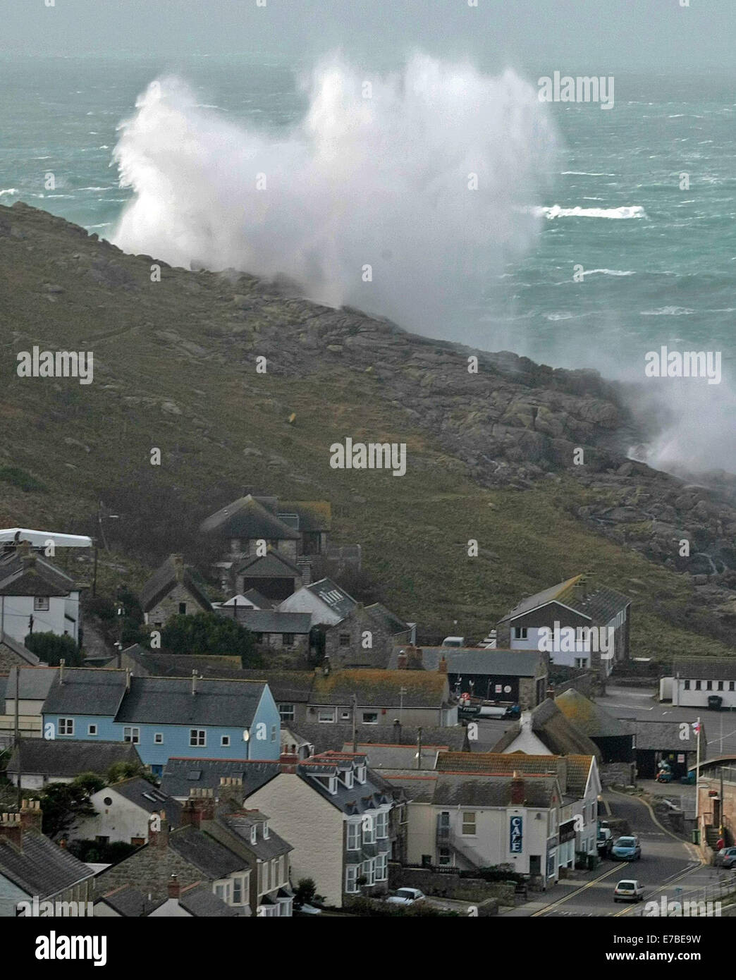 Waves crash into the seafront at Sennen Cove in Cornwall, as storms continue to batter the South West of England. Stock Photo