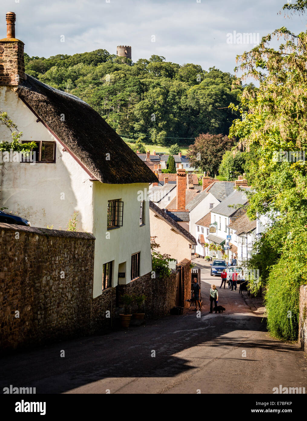 Looking down castle hill to the main village street of Dunster with Conygar Tower on the hill betond Somerset UK Stock Photo