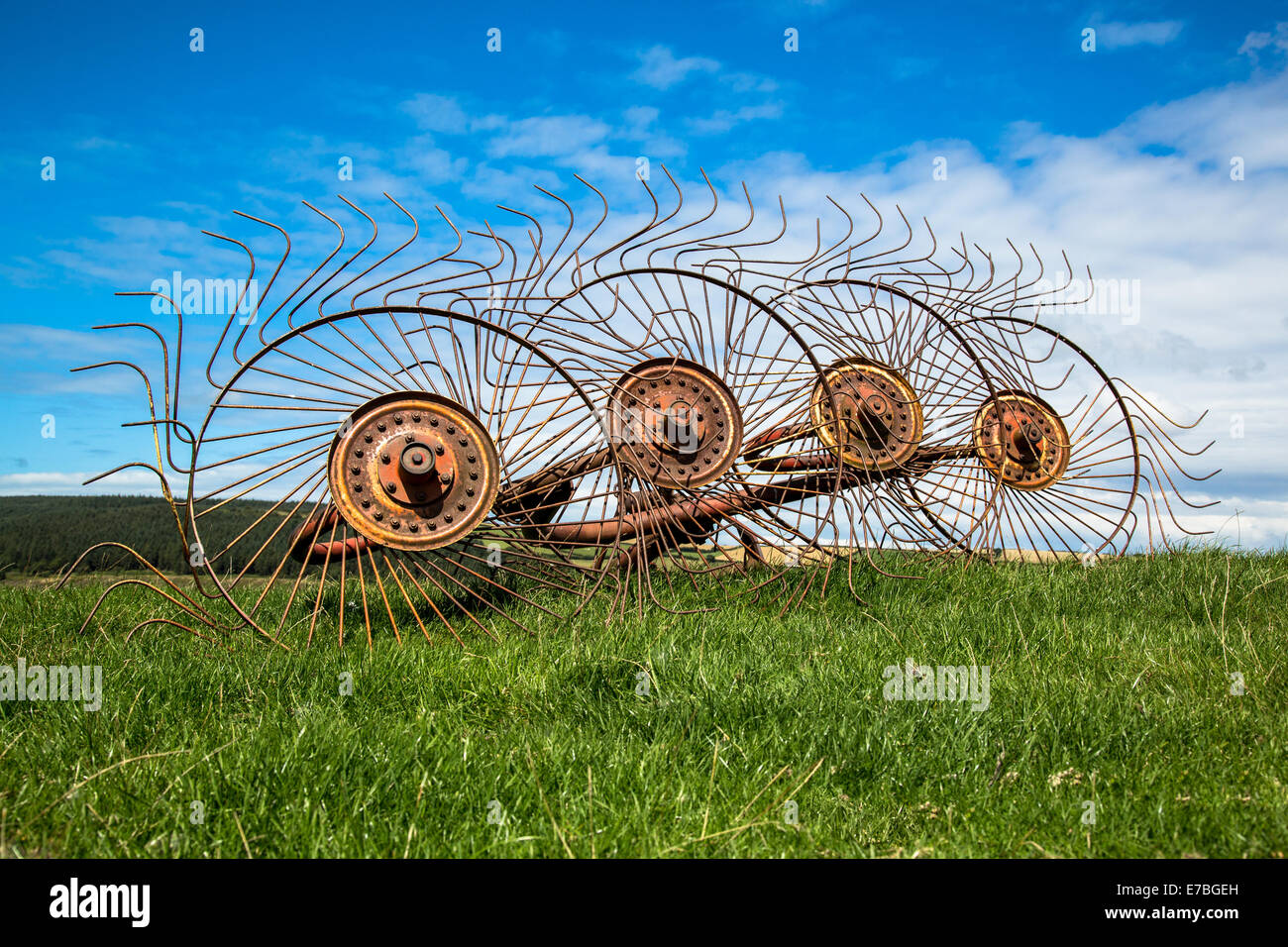 Old star wheel hay rake or windrow lying unused on a Somerset farm UK Stock Photo