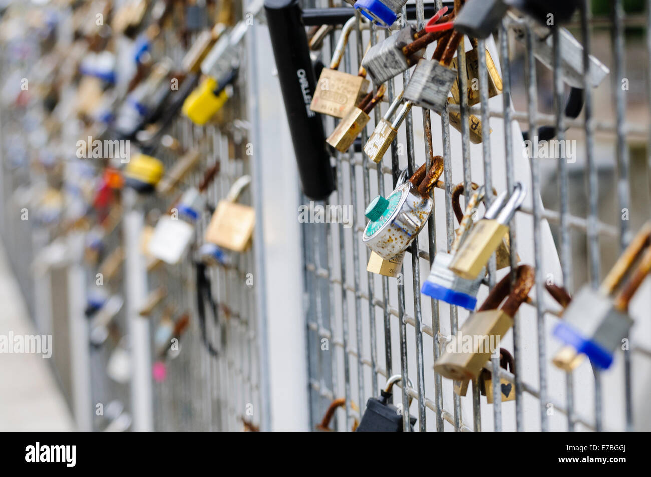 Padlocks on a bridge put there by lovers to show their love. Stock Photo
