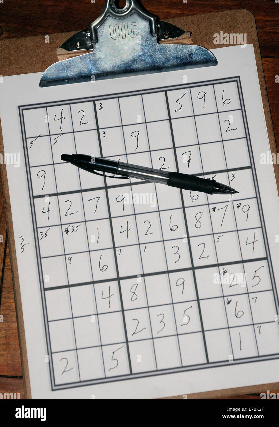 Clipboard with home-made Sudoku grid and game. Stock Photo
