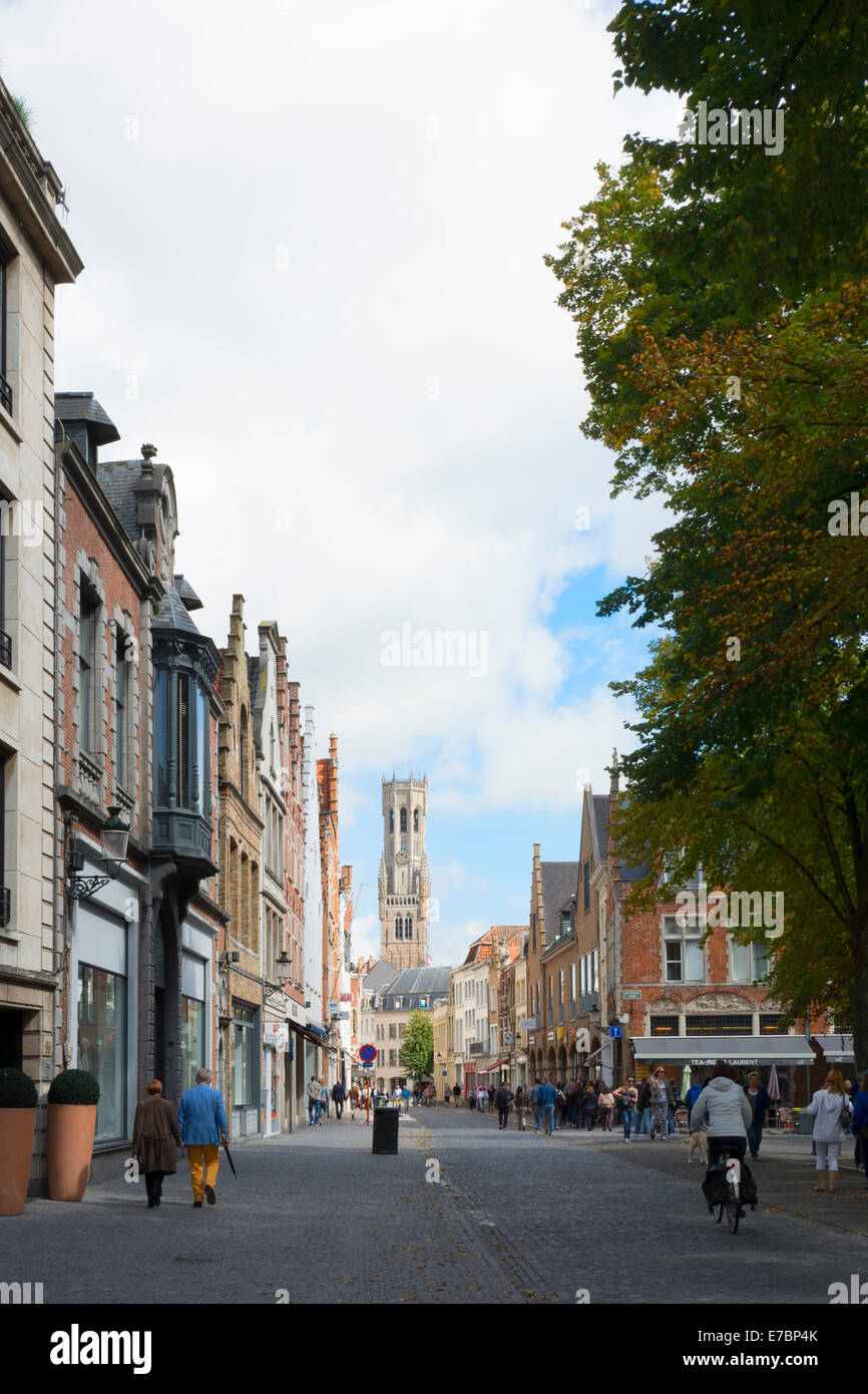 A view along the cobbled Steenstraat street to the Befort, the Belfry of Bruges in Belgium Stock Photo