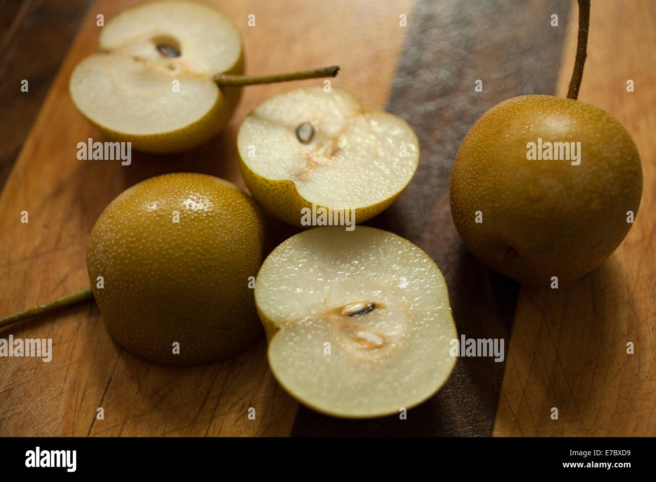 Small Asian Pears are cut open to show juicy interior. Stock Photo