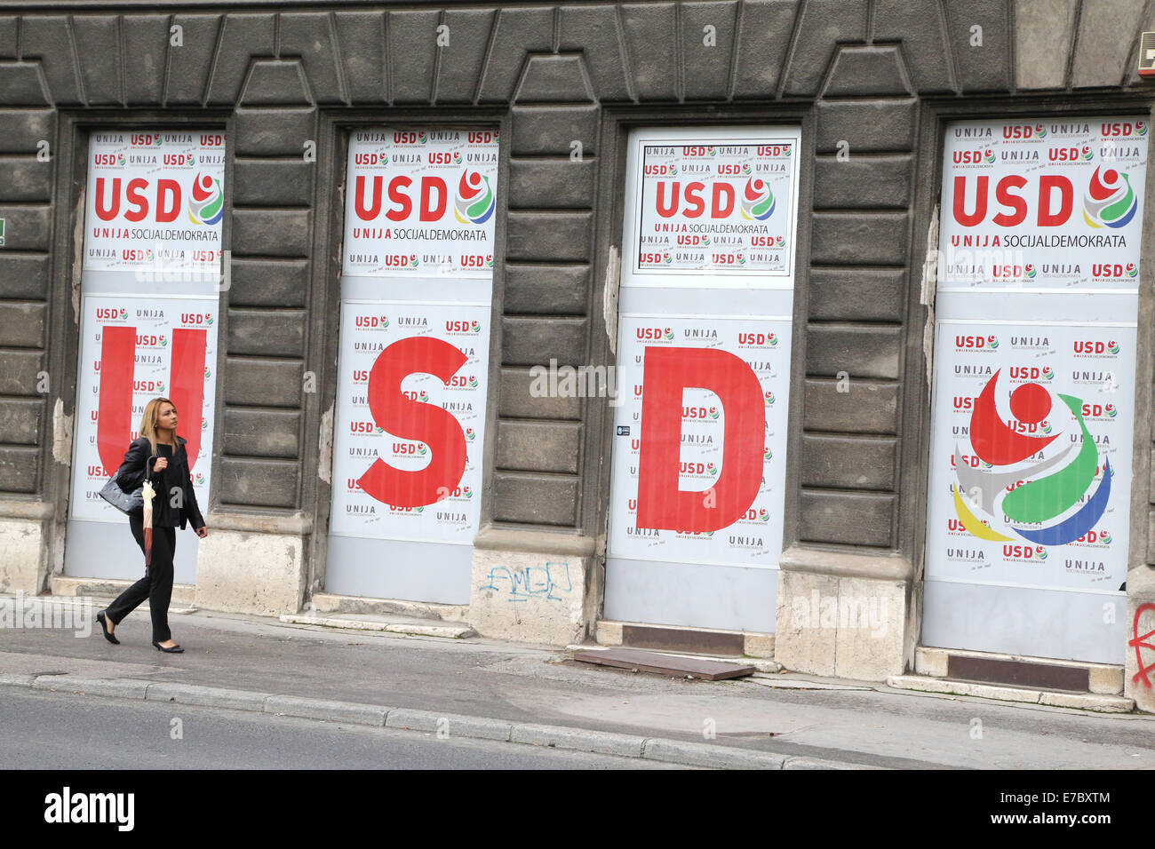 Sarajevo, Bosnia and Herzegovina. 12th Sep, 2014. A resident passes by a campaign poster in the center of Sarajevo, Bosnia and Herzegovina, on Sept. 12, 2014. With the month-long campaign for the general elections officially kicking off in BiH on Friday, the Balkan state begins the complex process to bring in new governments, assemblies and presidencies in different levels. © Haris Memija/Xinhua/Alamy Live News Stock Photo