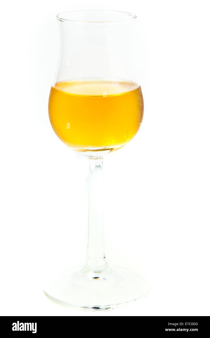 Glass of dark italian Grappa brandy isolated on white background Stock Photo