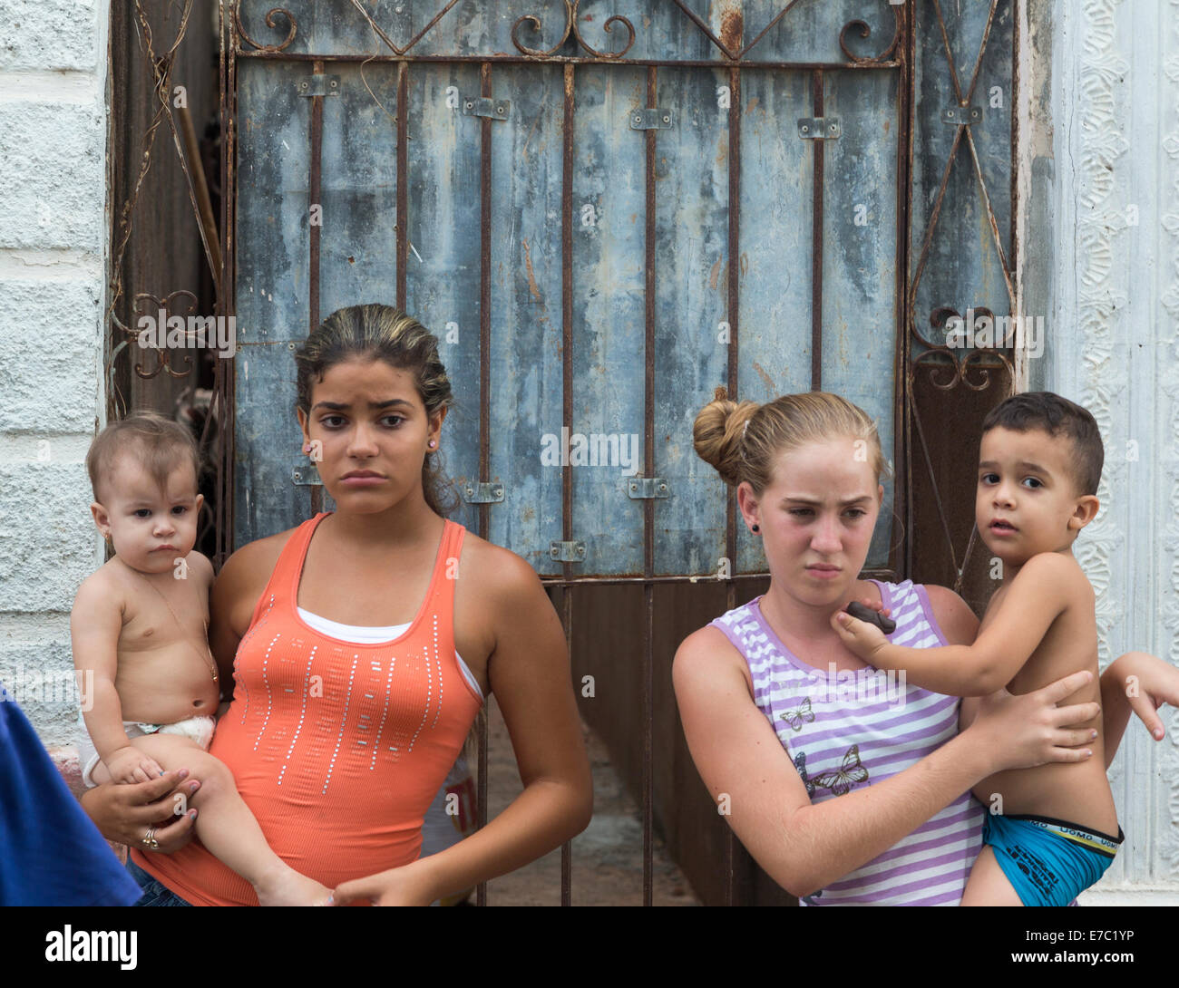 two young girls with babies, Trinidad, Cuba Stock Photo