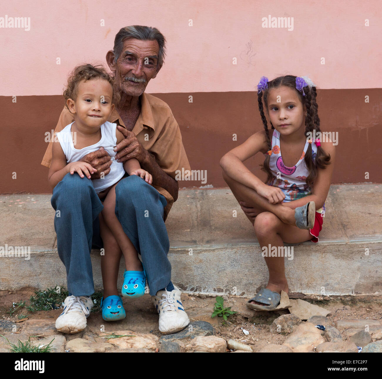 old man with two young children, Trinidad, Cuba Stock Photo