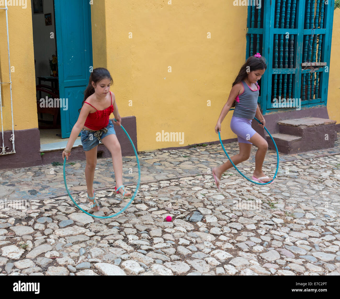 young girls playing with hula hoop, Trinidad, Cuba Stock Photo
