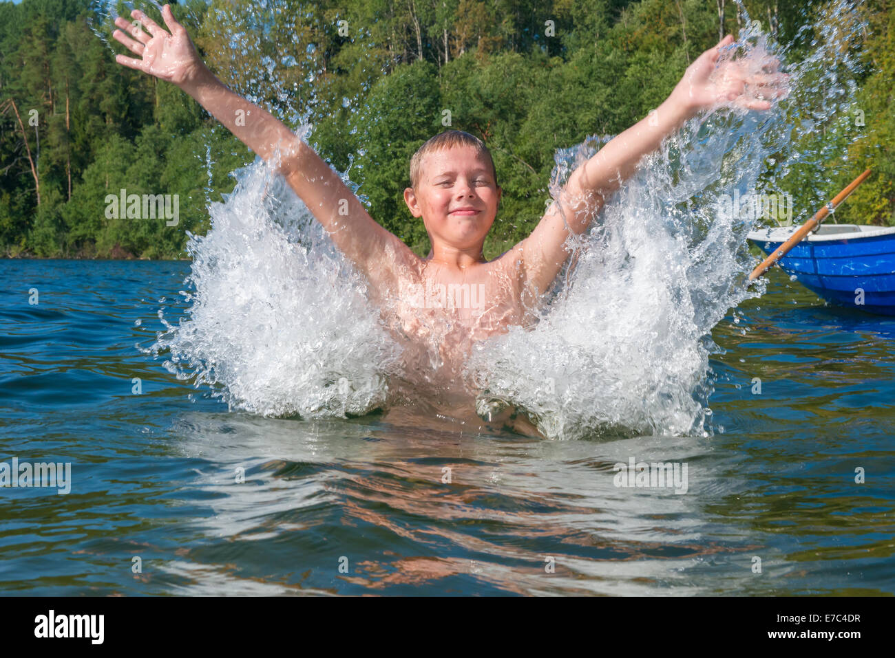 Young boy splash water in the lake Stock Photo