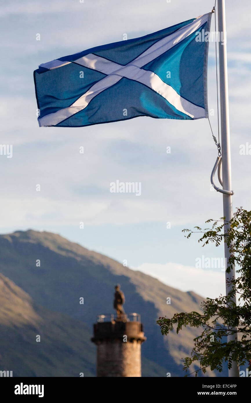 Saint Andrew's Cross Scottish Flag in the sky of Glenfinnan. Below the monument of Bonnie Prince Charlie Stock Photo
