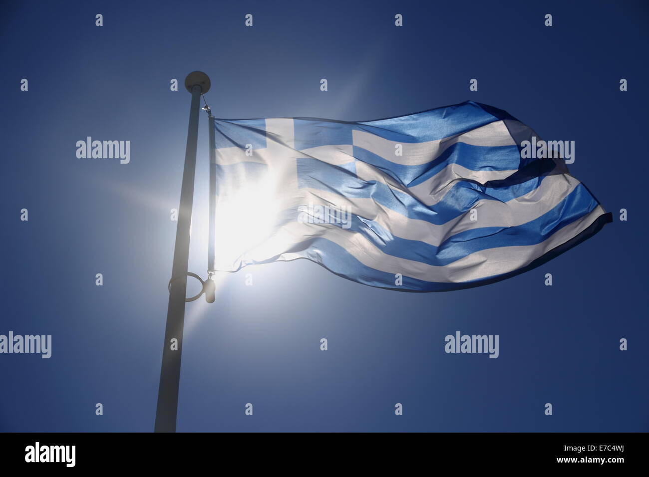 Greece flag on blue sky, backlit subject, contre-jour Stock Photo