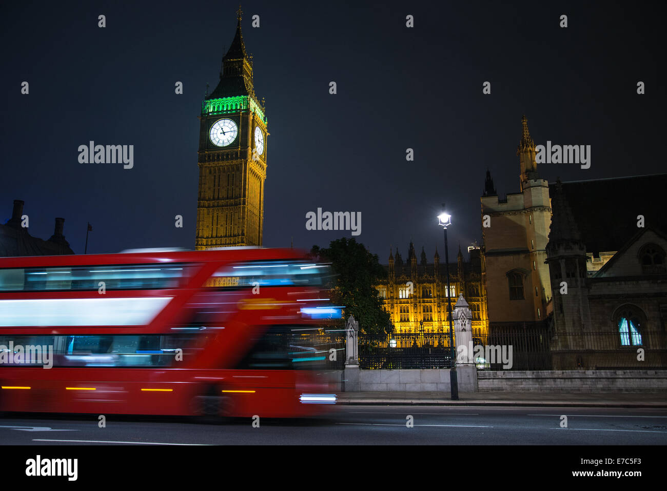 NIght view on Big Ben parliament house in Westmin and double decker classic London bus on London Bridge in London,United Kingdom Stock Photo