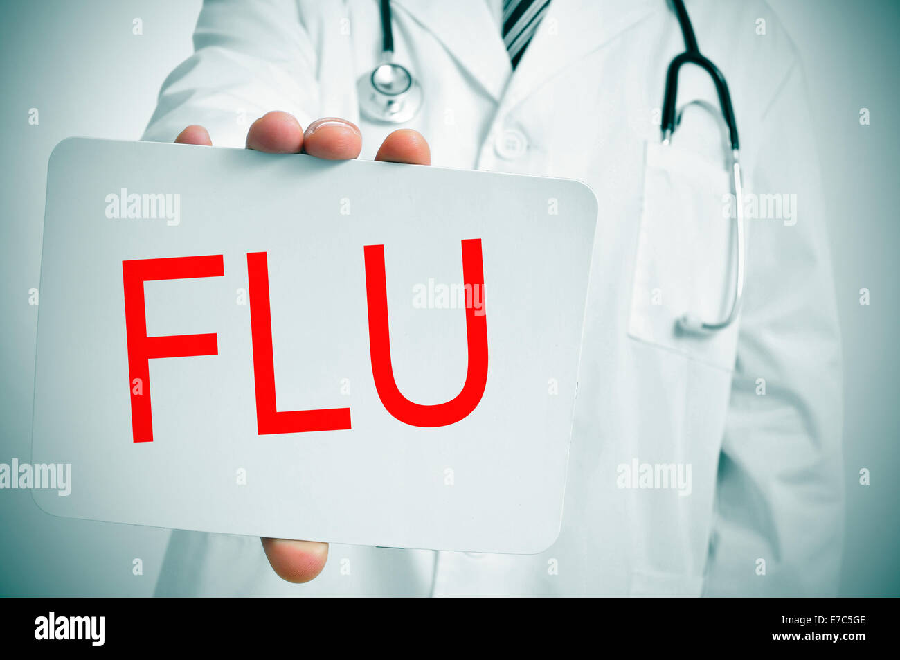 a doctor showing a signboard with the word flu written in it Stock Photo