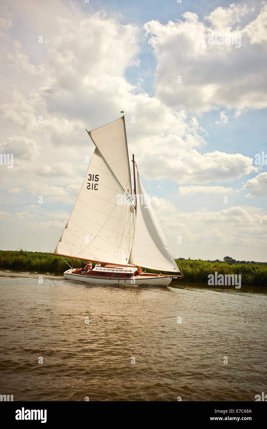 A Classic Gaff Rigged Norfolk Broads River Cruiser Yacht with a Topsail, The River Bure, Norfolk Broads, Norfolk, England, UK. Stock Photo