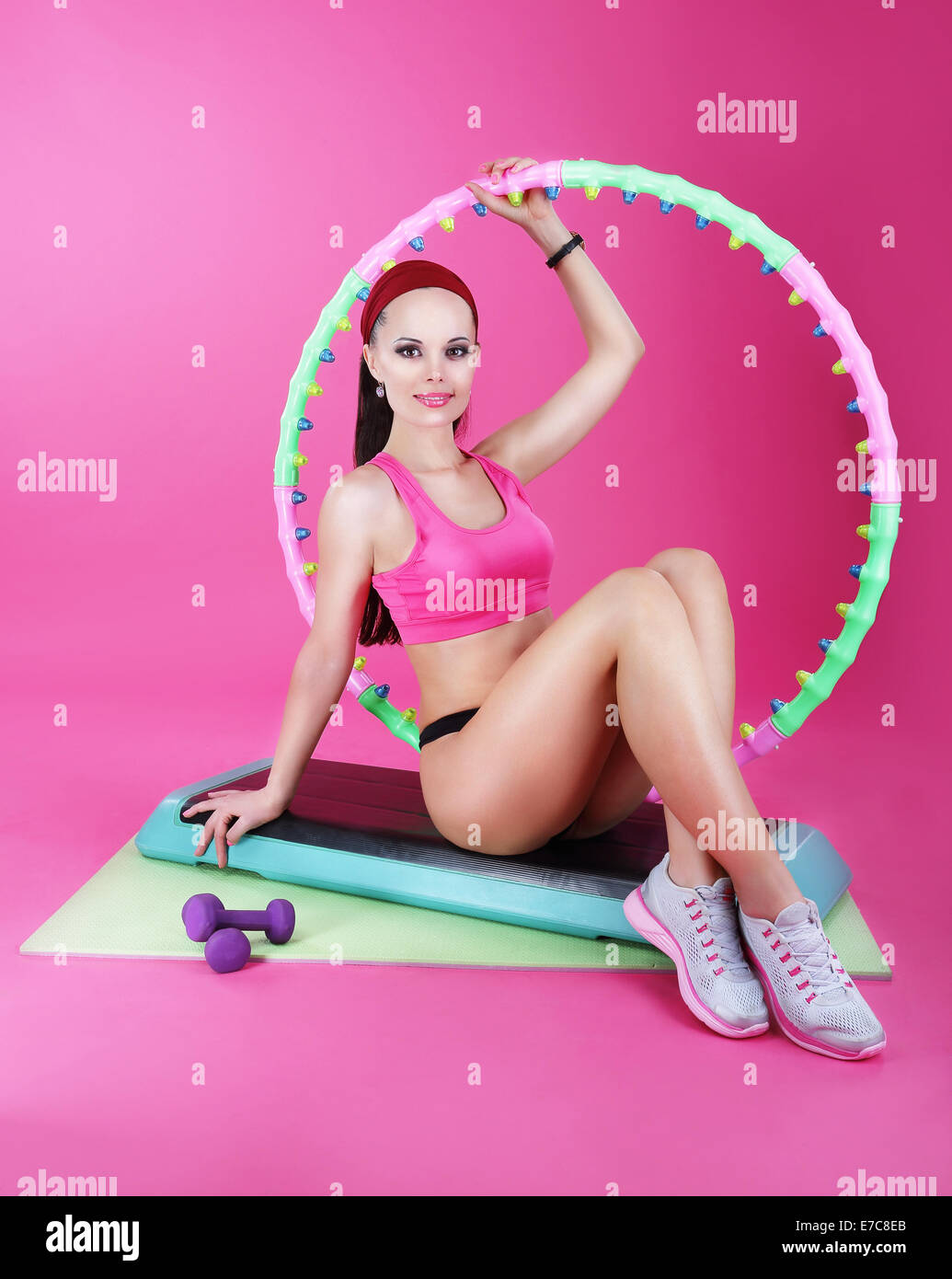Healthy Lifestyle. Sporty Woman Sitting on Mat with Fitness Equipment Stock Photo
