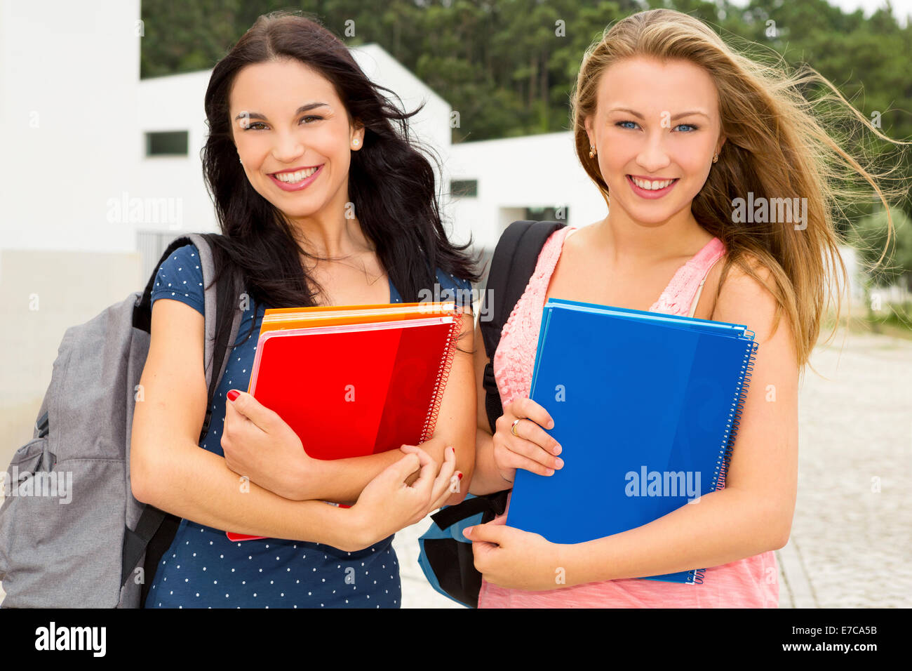 Two beautiful and happy teenage students smiling Stock Photo - Alamy