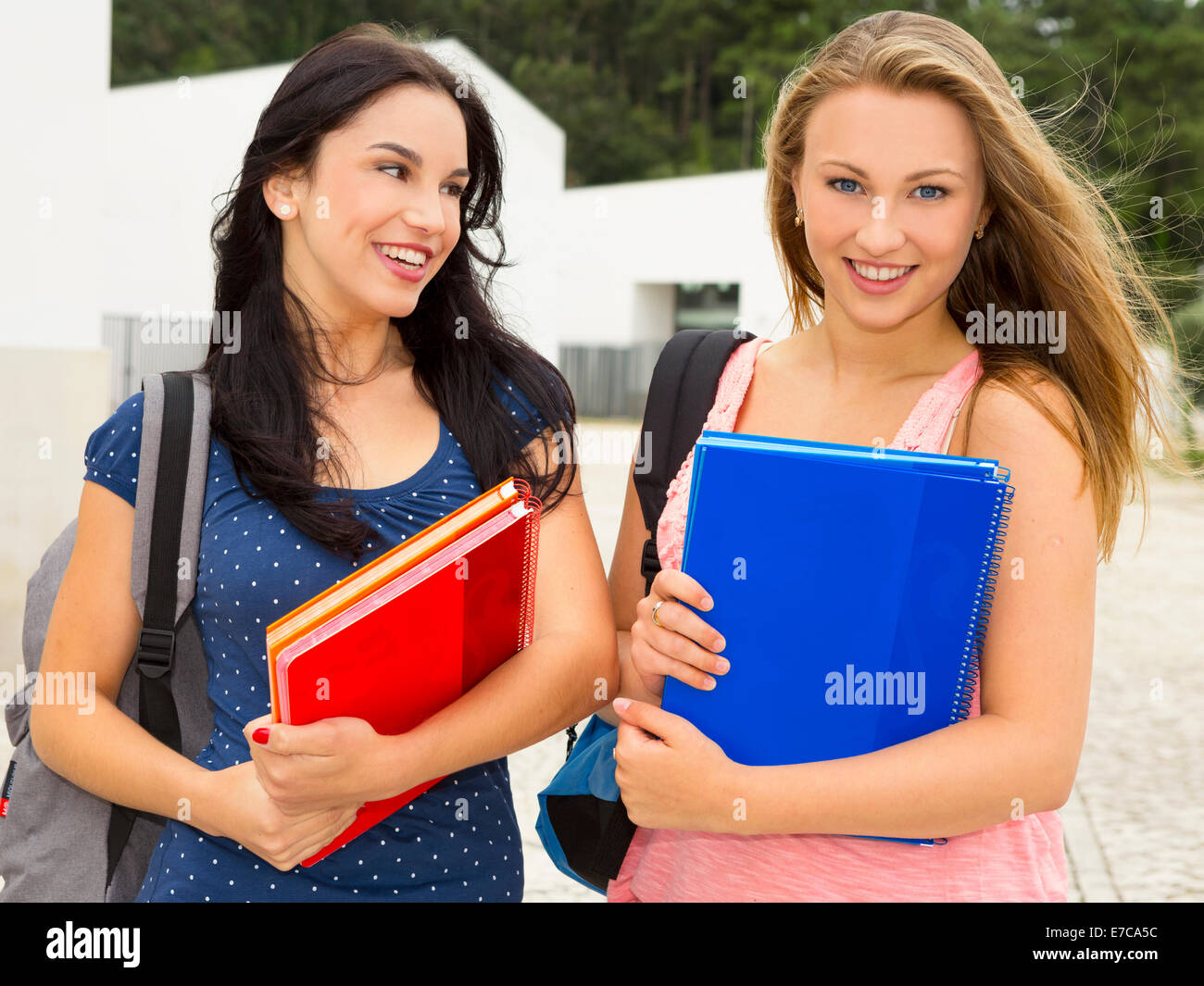 Two beautiful and happy teenage students smiling Stock Photo - Alamy