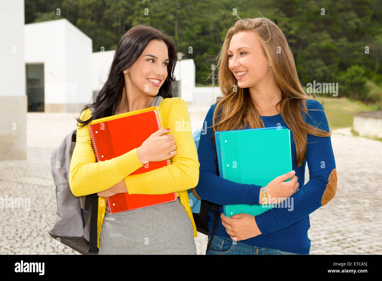 Two beautiful teenage students walking and smiling Stock Photo - Alamy