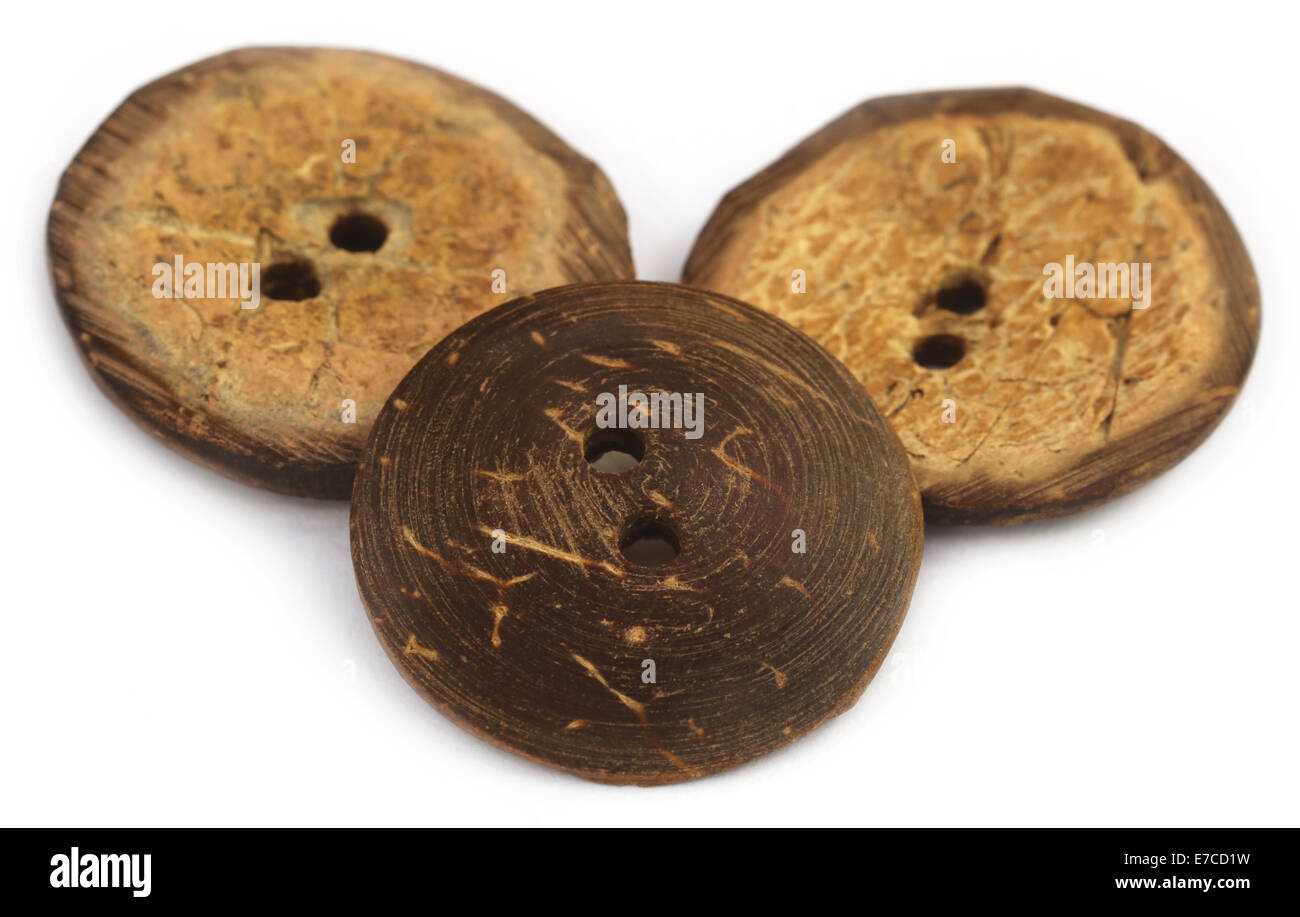 Round buttons made of coconut shell over white background Stock Photo