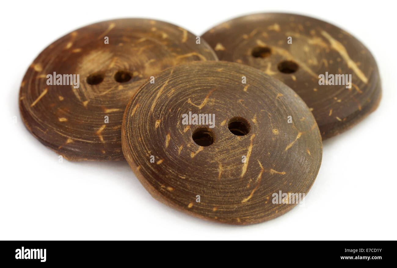 Round buttons made of coconut shell over white background Stock Photo