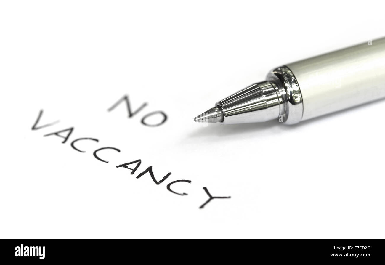 No vacancy written on a white paper with pen Stock Photo