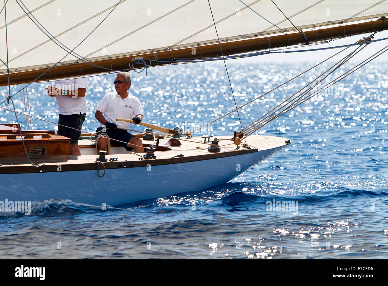 Imperia, Italy. 13th September 2014. A crew memeber at the helm during Vele d'Epoca classic yachts regatta, a vintage yachts competition held every two years in Imperia, Italy. Stock Photo