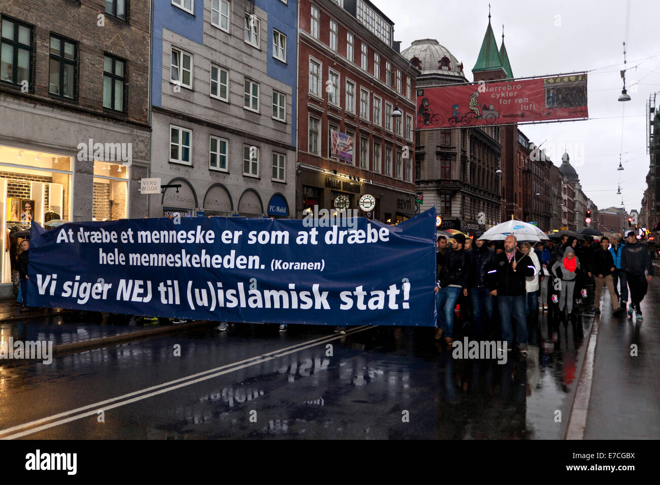 Copenhagen, Denmark. 13th September, 2014. Muslims walks in demonstration  through the streets of Copenhagen in protest against Islamic State (IS) and  it's warfare in Iraq and Syria. The large banner quotes the