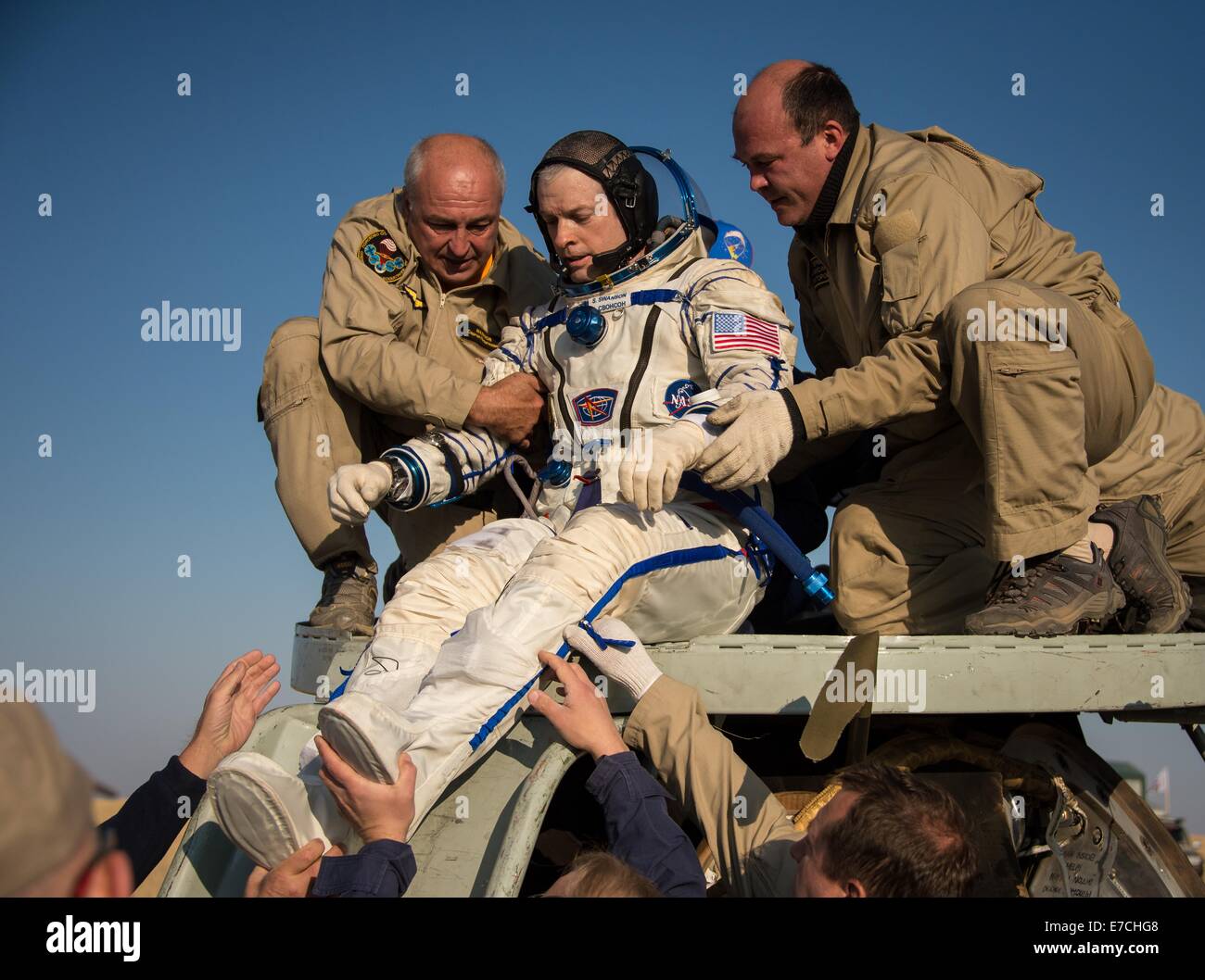 International Space Station Expedition 40 Commander Steve Swanson of NASA is helped out of the Soyuz Capsule just minutes after landing September 11, 2014 in Zhezkazgan, Kazakhstan. Swanson, Skvortsov and Artemyev returned to Earth after more than five months onboard the International Space Station where they served as members of the Expedition 39 and 40 crews. Stock Photo