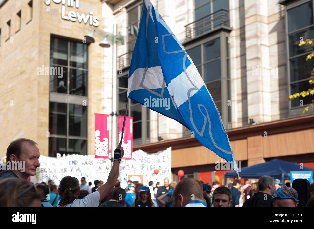 Glasgow, Scotland, UK. 13th September, 2014. A yes supporter campaigning and flying a st andrews cross flag during the lead up to the Scottish independence referendum on Buchanan Street, Glasgow, Scotland on Saturday 13th September 2014 Credit:  Iona Shepherd/Alamy Live News Stock Photo