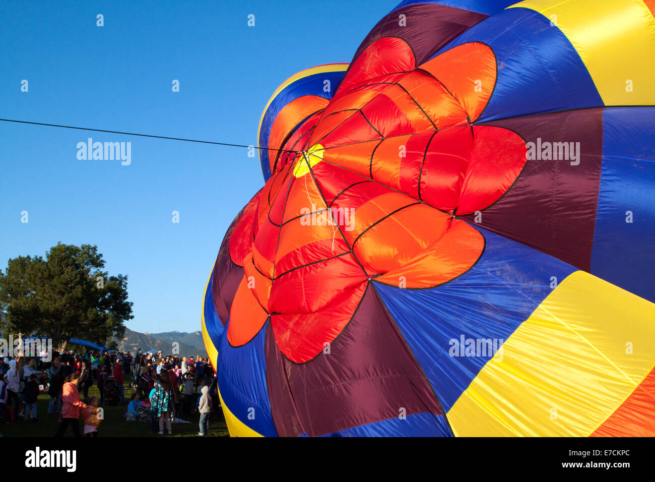 People watch as a colorful hot air balloon is inflated on the last day of the last scheduled Balloon Classic in Colorado Springs Stock Photo